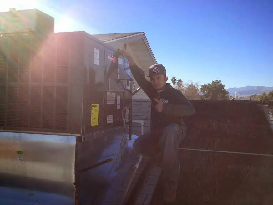 HVAC technician performing HVAC Inspection on a rooftop unit in Hillsboro